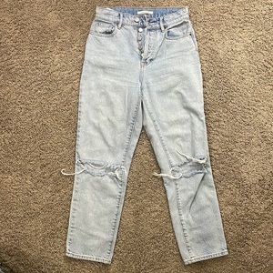 High rise straight jeans. Size 24. Distress at knees.